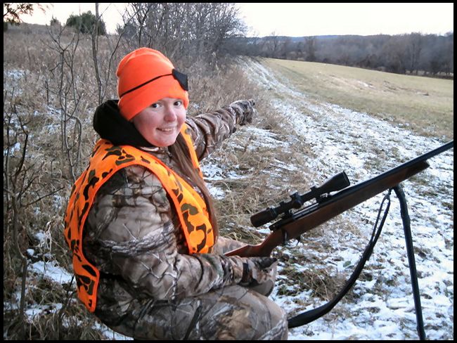 pointing to her doe down in the field